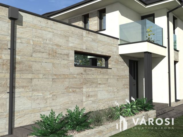 Tágas ,napfényes ikerház családbarát környéken eladó